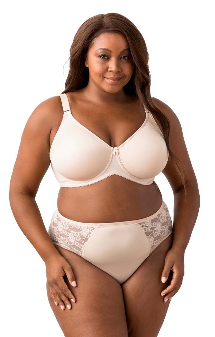 Woman wearing a beige bra and panties set on a white background