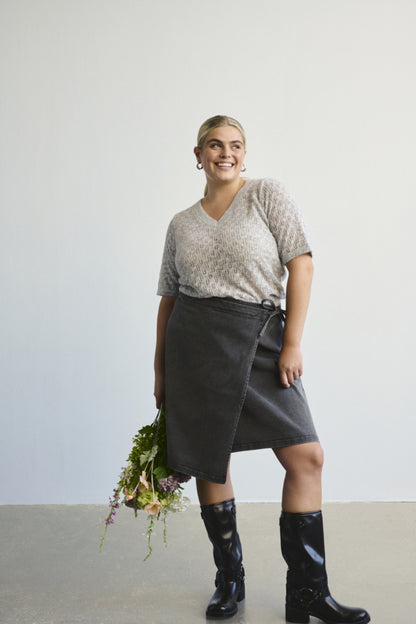 Model wearing Sina Denim Wrap Skirt in washed black, styled with boots – Pinned Up Bra Lounge Markham.