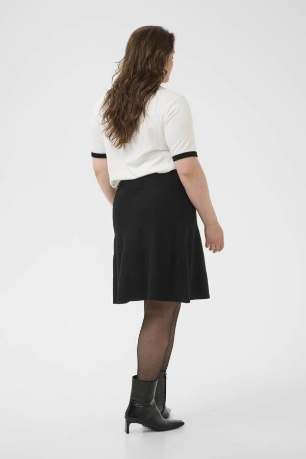 Kaffe Curve black skirt styled casual with tee back view on white background