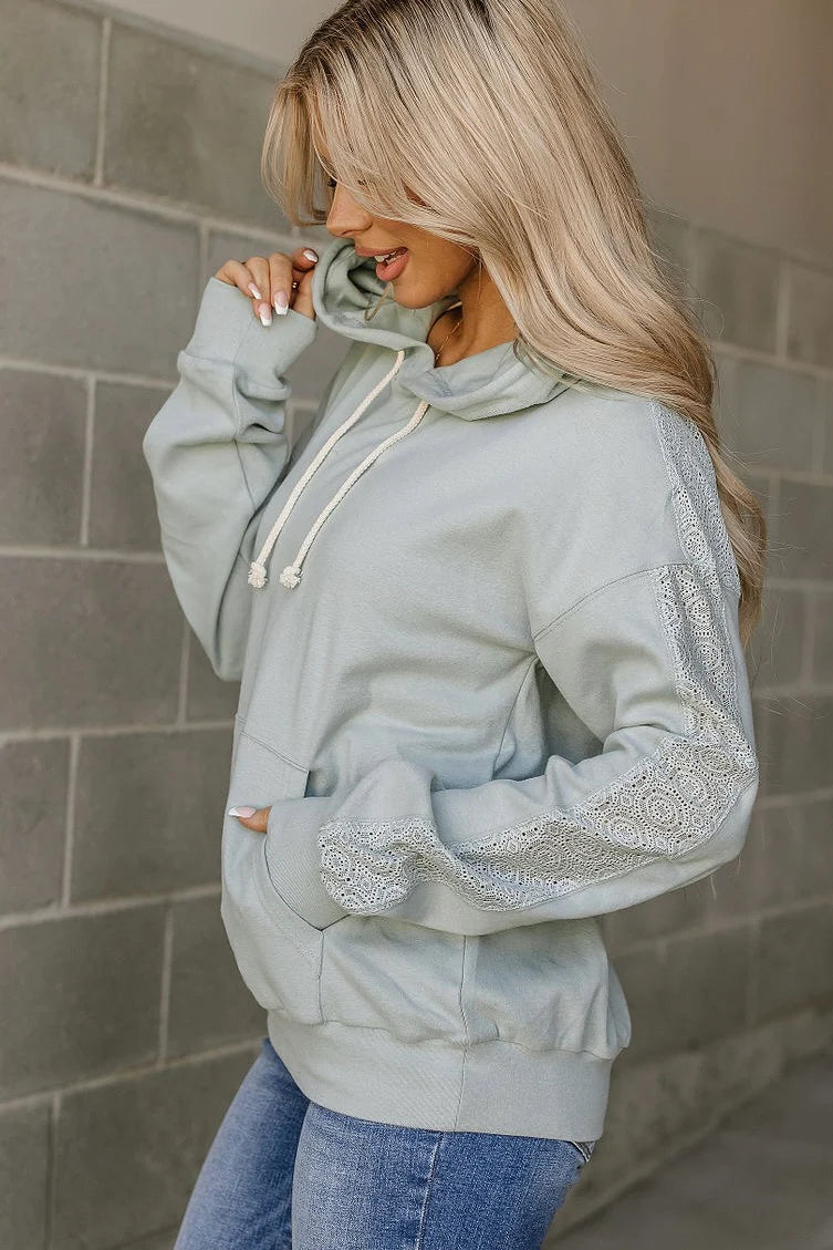 Ampersand Avenue University Hoodie in Wonderstruck Blue showing lace sleeve detail and kangaroo pocket from the side. 