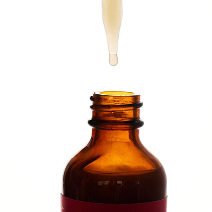 Amber glass dropper bottle with a white dropper on a white background