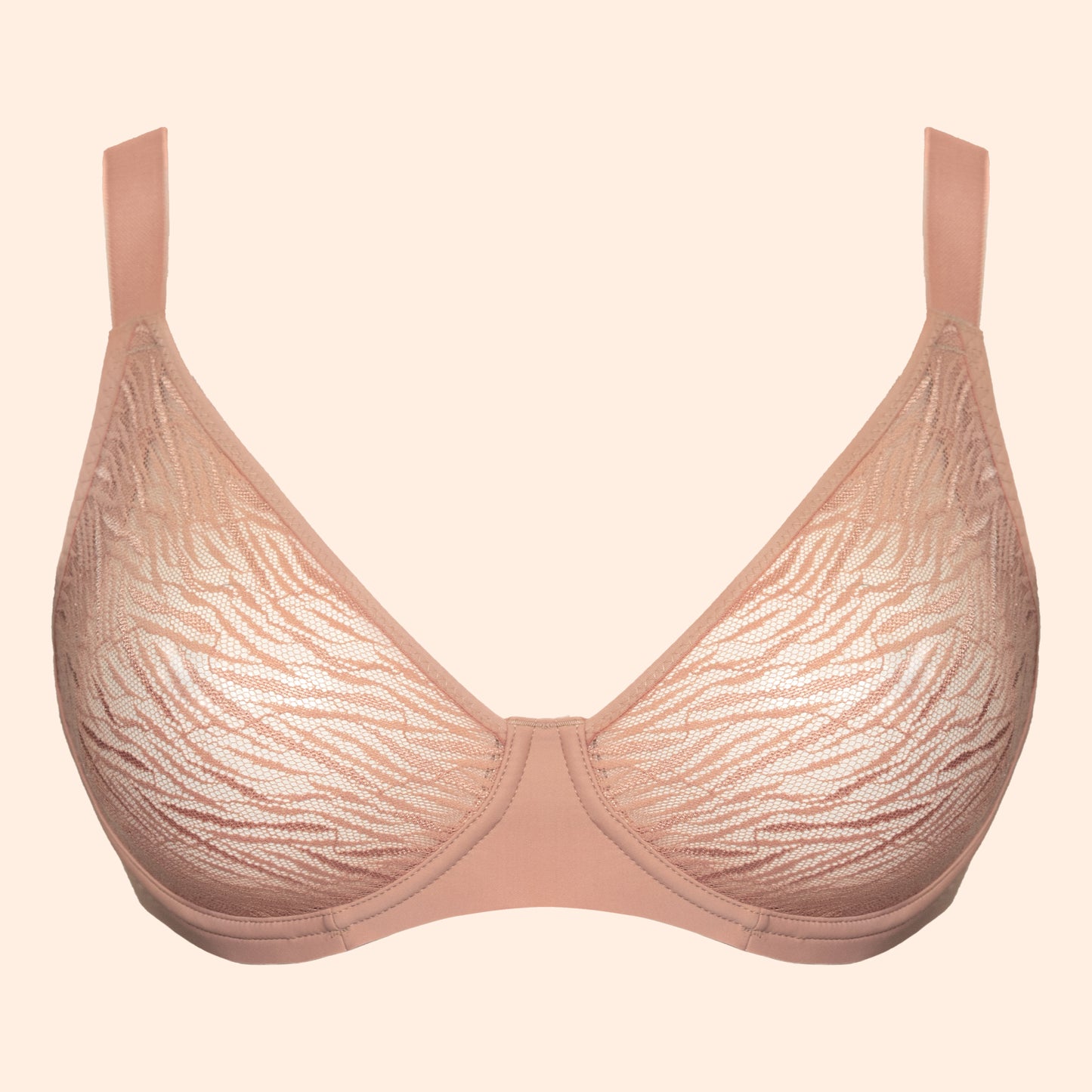 A light beige lace bra with a subtle wavy pattern, shown against a solid pale peach background.