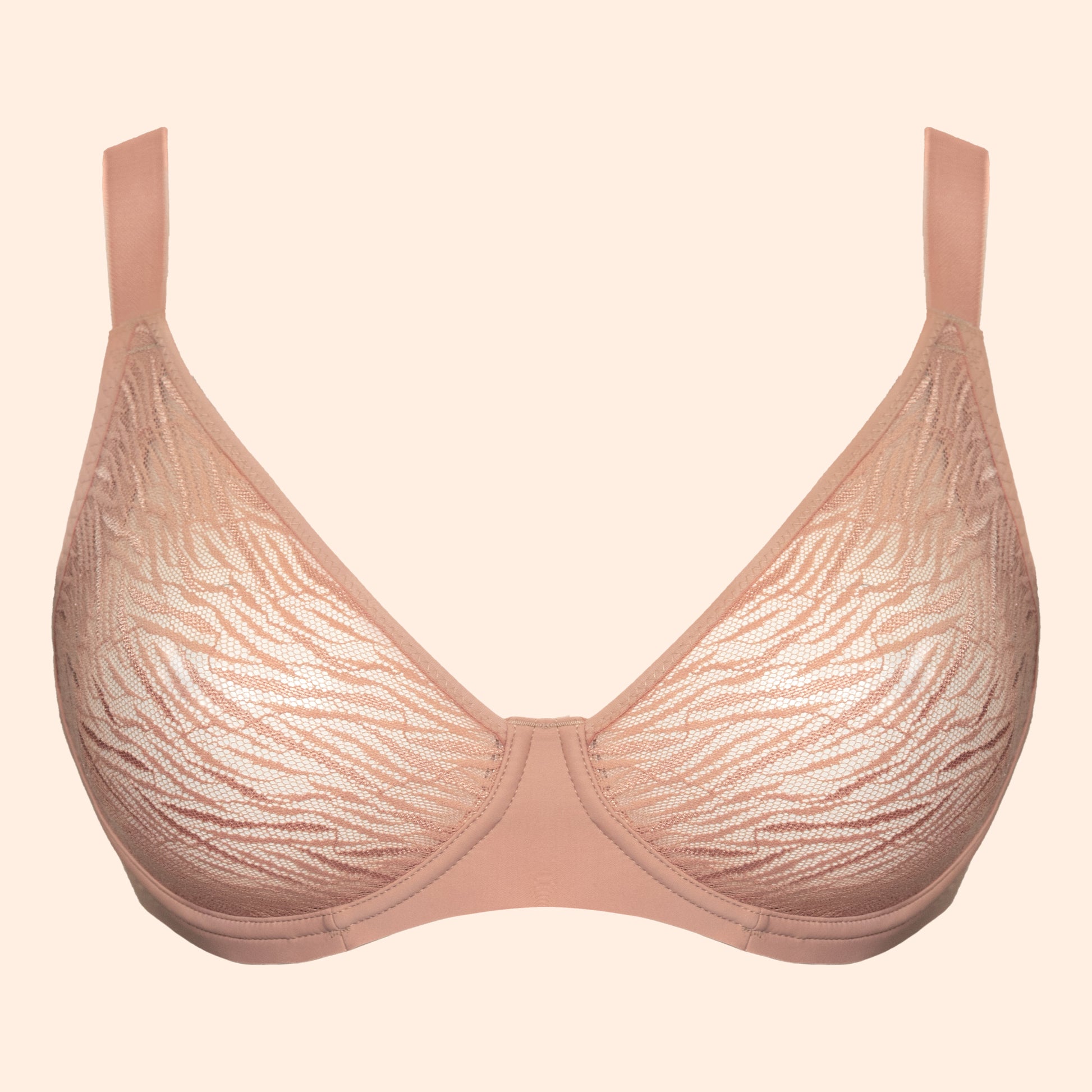 A light beige lace bra with a subtle wavy pattern, shown against a solid pale peach background.