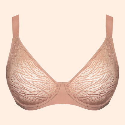 A light beige lace bra with a subtle wavy pattern, shown against a solid pale peach background.